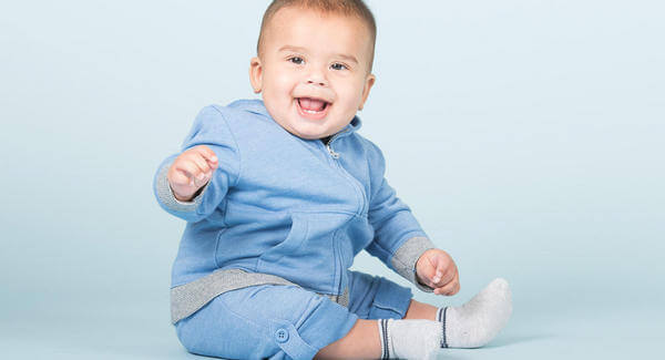 oturan mavi kıyafetli bebek